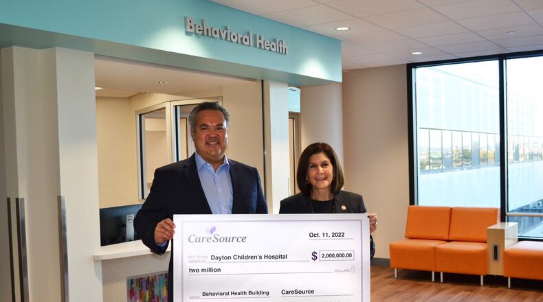 CareSource president and CEO, Erhardt Preitauer, presents a $2 million donation to Debbie Feldman, president and CEO of Dayton Children’s Hospital. The donation will go toward Dayton Children's new behavioral health building, which they plan to break ground on in 2023 and open in 2025. CONTRIBUTED