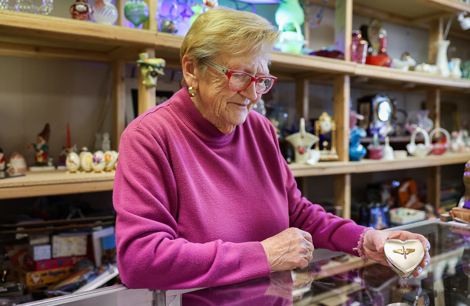 Gale Hutchinson, a co-owner of Pappy's Place in downtown Xenia, looks at an item on Monday. The antique store is moving from its current location on West Main Street to a larger location on East Main Street. BRYANT BILLING / STAFF