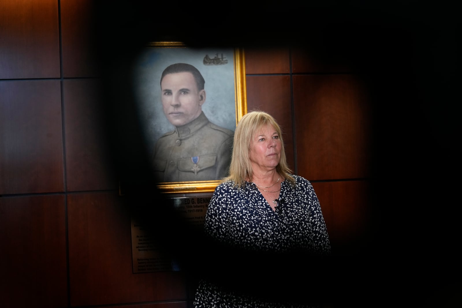 Ms. Sue Conger-Williams, Fred Benning's granddaughter gives and interview in front of her grandfathers portrait hanging at Fort Benning during a ceremony honoring new namesake on Wednesday, April 16, 2025, in Fort Benning, Ga. (AP Photo/Brynn Anderson)