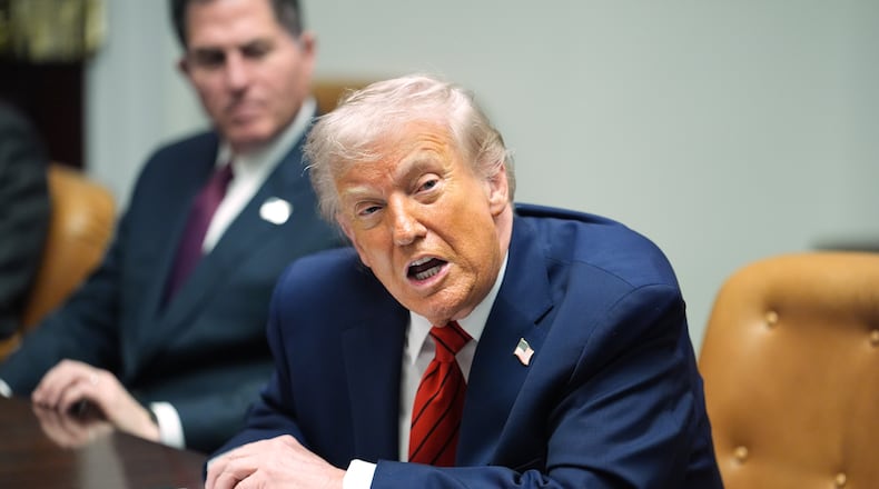 Sitting next to founder and CEO of Dell, Michael Dell, left, President Donald Trump speaks during a roundtable discussion with business leaders in the Roosevelt Room of the White House, Wednesday, Dec. 10, 2025, in Washington. (AP Photo/Evan Vucci)