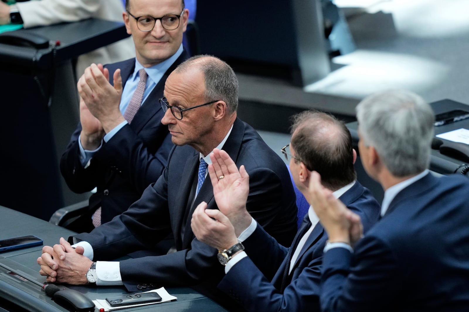 Leader of the Christian Democrats Friedrich Merz is applauded after being elected new chancellor at the German federal parliament, Bundestag, at the Reichstag building in Berlin, Germany, Tuesday, May 6, 2025. (AP Photo/Ebrahim Noroozi)