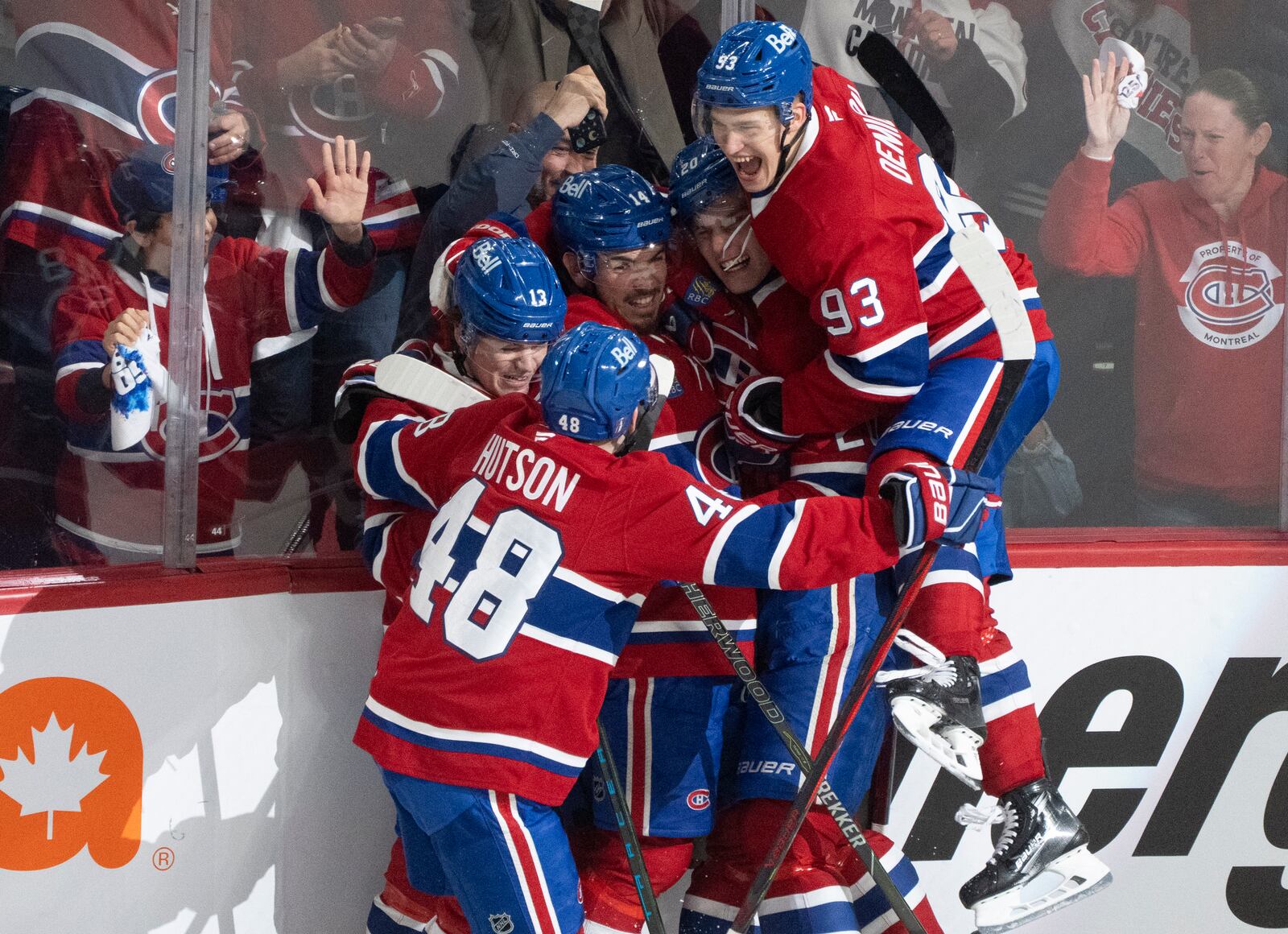 Montreal Canadiens' Nick Suzuki, center, celebrates his goal against the Washington Capitals with teammates during the second period of an NHL hockey playoff game in Montreal on Friday, April 25, 2025. (Christinne Muschi/The Canadian Press via AP)