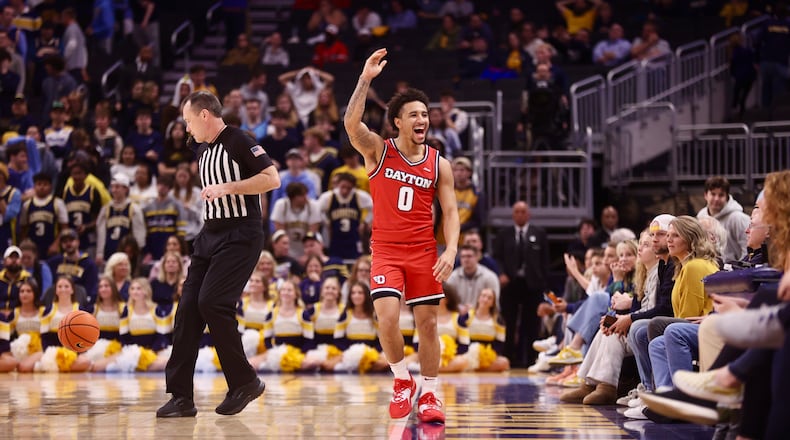 Dayton's Javon Bennett waves to fans in the final minute of a victory against Marquette on Wednesday, Nov. 19, 2025, at Fiserv Arena in Milwaukee, Wis. David Jablonski/Staff