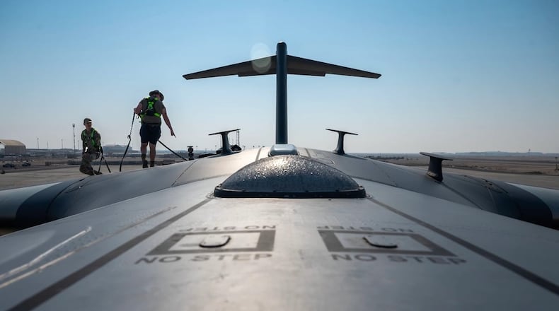 U.S. Air Force Senior Airmen Victor Sandoval Gutierrez, left, and Staff Sgt. Ethan Stone, right, Expeditionary Airlift Squadron avionics technicians, inspect a C-17 Globemaster III at an undisclosed location in the U.S. Central Command area of responsibility (AOR), Dec. 8, 2023. (U.S. Air Force photo by Senior Airman Sarah Williams)