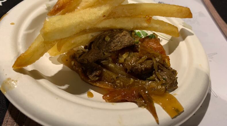 Salar Restaurant and Lounge served Beef Saltado, pan seared strips of filet mignon with sauteed onions, tomatoes, yellow Peruvian peppers and spices tossed with French fries over Jasmine rice during the Miami Valley Restaurant Association's Sneak Peek to Winter Restaurant Week on Jan. 15, 2020, at Dayton's Steam Plant. More than 50 restaurants will offer 3-course meal deals priced at $20.20, $25.20, or $30.20 from Jan. 19-26 as part of the Winter Restaurant Week promotion. ALEXIS LARSEN/CONTRIBUTED