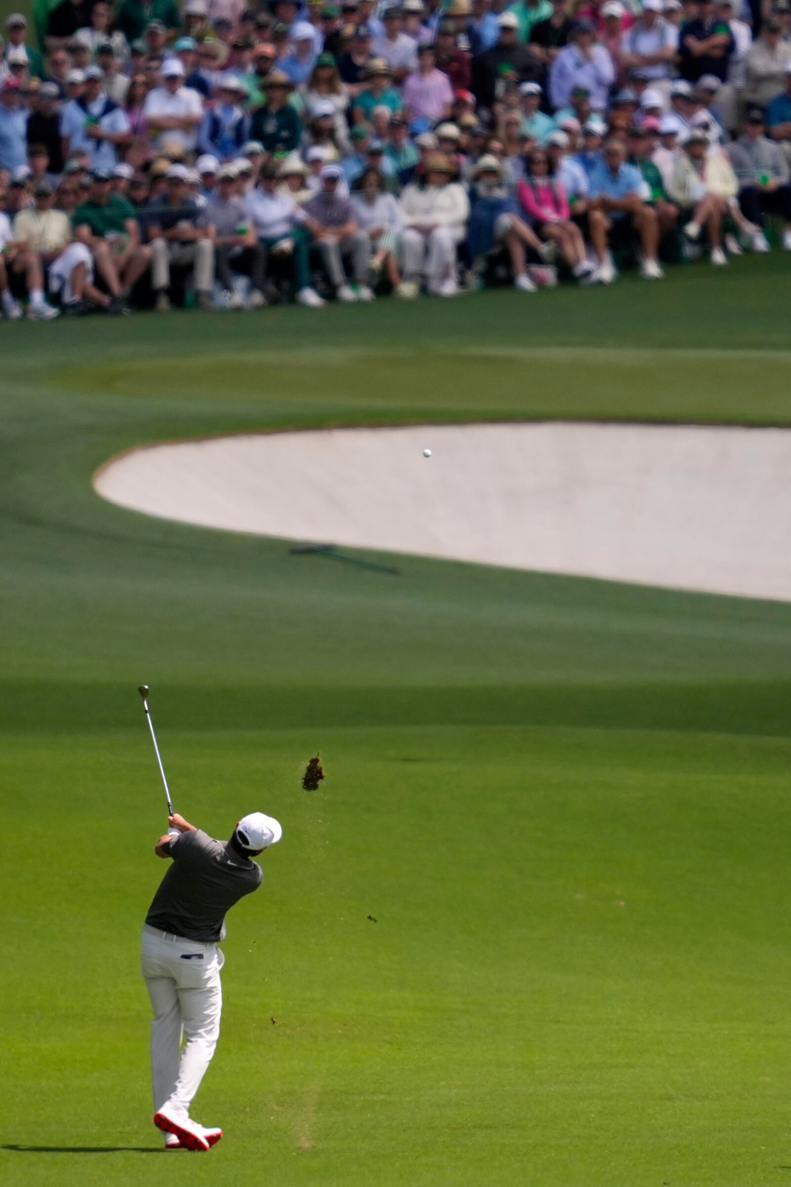 Scottie Scheffler hits from the fairway on the second hole during the third round at the Masters golf tournament, Saturday, April 12, 2025, in Augusta, Ga. (AP Photo/Ashley Landis)