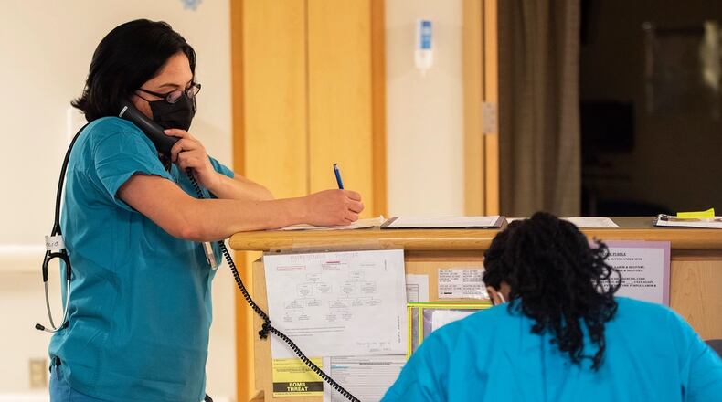 Capt. Dahlia Garcia, 88th Inpatient Operations Squadron charge nurse, takes notes as she talks to an expectant mother on the phone Dec. 16, 2021, during her overnight shift with Wright-Patterson Medical Center’s Labor and Delivery Ward.  (U.S. Air Force photo by R.J. Oriez)