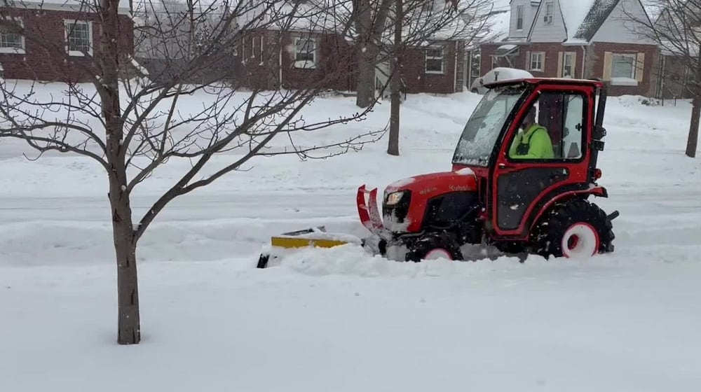 A city of Oakwood employee plows the sidewalk in the 1600 block of Shroyer Road, during a major snow storm on Sunday, Jan. 25, 2026. JEN BALDUF/STAFF