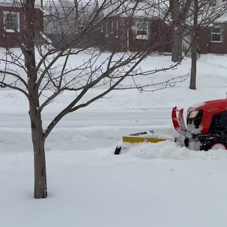 A city of Oakwood employee plows the sidewalk in the 1600 block of Shroyer Road, during a major snow storm on Sunday, Jan. 25, 2026. JEN BALDUF/STAFF