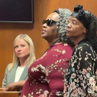 Gloria Courtney, who was blinded in an October 2023 attack while working as a security guard at the Premier Health building downtown, says she forgives her assailant, James Fickling, during his sentencing Friday, March 13, in Montgomery County Common Pleas Court. At right is Courtney's daughter, Oletha Courtney and at left is Jennifer Buschur of the prosecutor's office JEN BALDUF/ STAFF