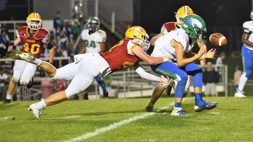 Fenwick’s Ben Gustely (47) and Joe Perrotti (43) apply the pressure as Chaminade Julienne quarterback Luke Chandler fumbles the ball during Friday night’s game at Krusling Field in Middletown. Fenwick posted a 34-19 win. CONTRIBUTED PHOTO BY ANGIE MOHRHAUS