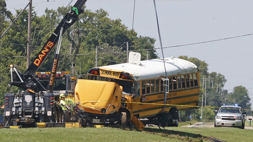 A Northwestern School District bus is uprighted by a crane after it was involved in a crash with another vehicle and rolled over. Twenty three children were transported to the hospital after the crash and one child was killed when they were ejected. BILL LACKEY/STAFF