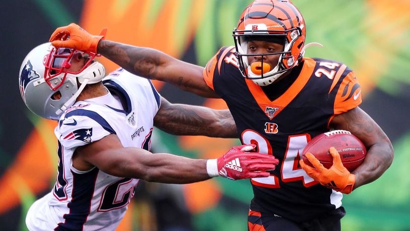 CINCINNATI, OHIO - DECEMBER 15: Darius Phillips #24 of the Cincinnati Bengals stiff arms Justin Bethel #29 of the New England Patriots on a kickoff return during the second half in the game at Paul Brown Stadium on December 15, 2019 in Cincinnati, Ohio. (Photo by Bobby Ellis/Getty Images)
