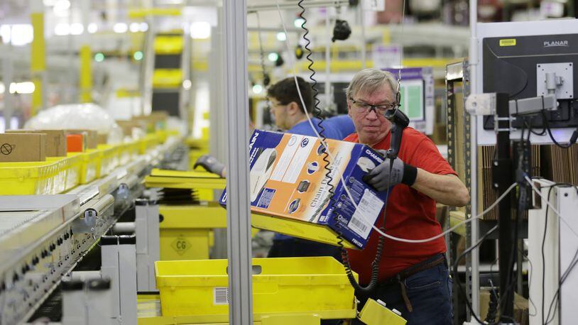 Mark Oldenburg processes outgoing orders at Amazon.com’s fulfillment center in DuPont, Wash. Shoppers spent more than $3 billion online this “Cyber Monday,” making it the biggest online shopping day ever. (AP Photo/Ted S. Warren, File)