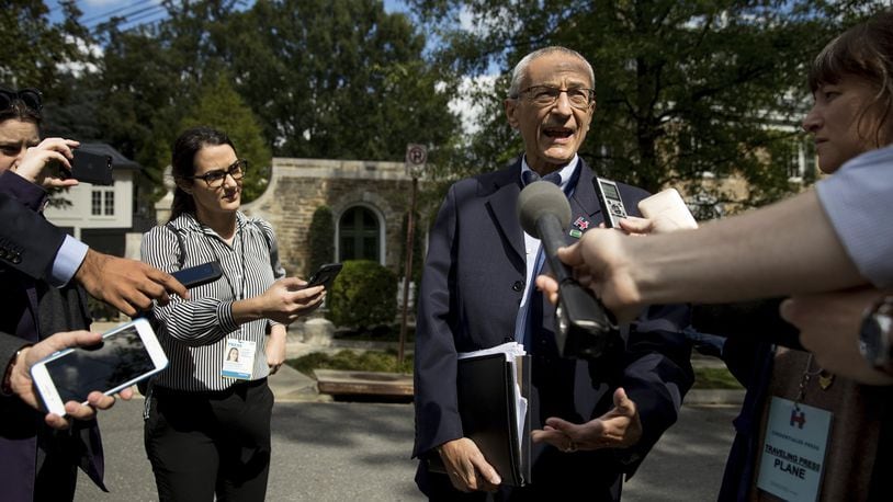 In this photo taken Oct. 5, 2016, Hillary Clinton’s campaign manager John Podesta speaks to members of the media outside Democratic presidential candidate Hillary Clinton’s home in Washington. (AP Photo/Andrew Harnik)
