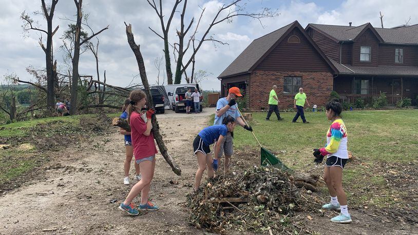 Carroll students clean up tornado debris on Wednesday in Dayton. NOLAN SIMMONS / STAFF