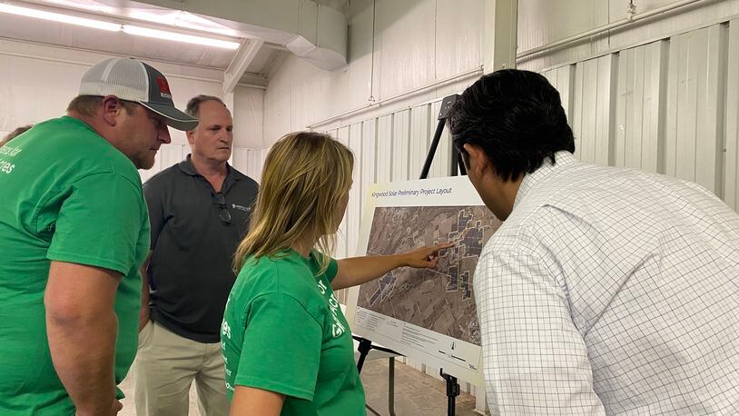 Locals speak with Dylan Stickney, right, about the proposed solar power project in Greene County. Eileen McClory / Staff