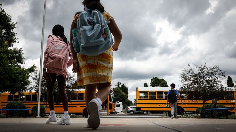 Children at Cline Elementary School in Centerville load into buses after the first day of school Wednesday August 18, 2021. All of the kids were wearing masks. JIM NOELKER/STAFF