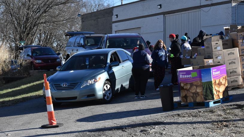 Volunteers from the nonprofit With God's Grace load up approximately 1,000 local families with Thanksgiving food on Sunday, Nov. 20, 2022. In addition to sides, families also either got a turkey or a gift card to a local grocery store. SAMANTHA WILDOW/STAFF