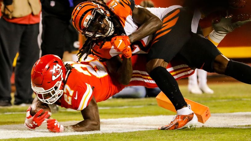 KANSAS CITY, MO - OCTOBER 21: Kareem Hunt #27 of the Kansas City Chiefs crosses over the goal line scoring the games first touchdown through the tackle attempt of Dre Kirkpatrick #27 of the Cincinnati Bengals in the first quarter at Arrowhead Stadium on October 21, 2018 in Kansas City, Kansas. (Photo by David Eulitt/Getty Images)