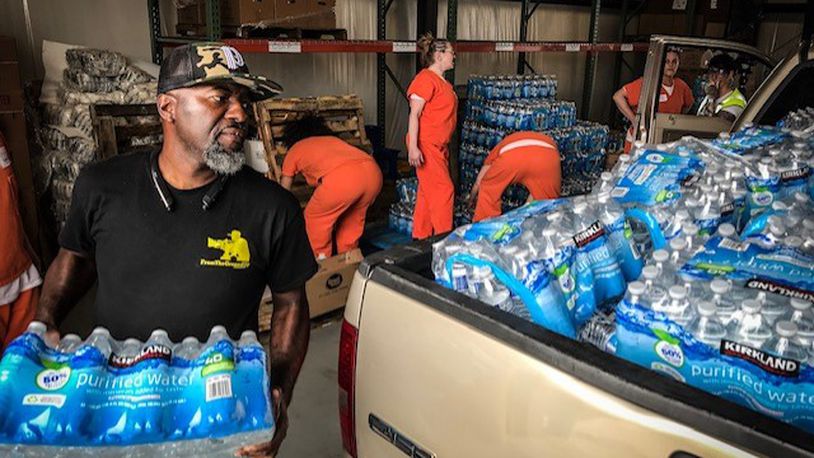 Bottled water is being distributed at The Foodbank in Dayton on Armor Place after the Memorial Day tornadoes. JIM NOELKER / STAFF