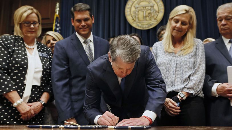 Surrounded by supporters of the bill, including Sen. Renee Unterman (from left), R - Buford, Lt. Gov. Geoff Duncan, First Lady Marty Kemp, and House Speaker David Ralston,  Gov. Brian Kemp signed HB 481, the "heartbeat bill", on Tuesday, setting the stage for a legal battle as the state attempts to outlaw most abortions after about six weeks of pregnancy.  The bill, sponsored by Rep. Ed Setlzer, R-Acworth, and carried in the Senate by Sen. Renee Unterman, R - Buford, outlaws most abortions once a doctor can detect a fetus' heartbeat - usually around six weeks of pregnancy.   Bob Andres / bandres@ajc.com
