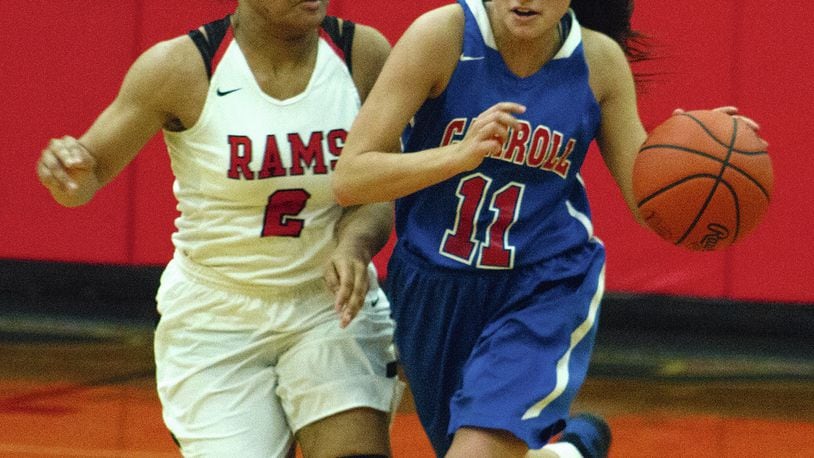 Carroll’s Marina Stevens dribbles up the court in the fourth quarter Tuesday night against Trotwood-Madison’s Myla Barnes. Carroll won 52-41. JEFF GILBERT / CONTRIBUTOR