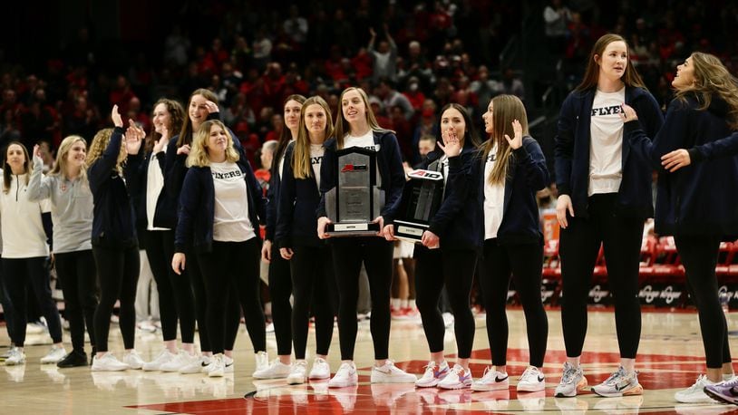 The Dayton volleyball team is honored during a men's basketball game against Rhode Island on Friday, Jan. 28, 2022, at UD Arena. David Jablonski/Staff