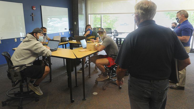 Some University of Dayton students saw their instructors face-to-face Wednesday as the university begins its first day of in-person classes for select courses. MARSHALL GORBY/STAFF