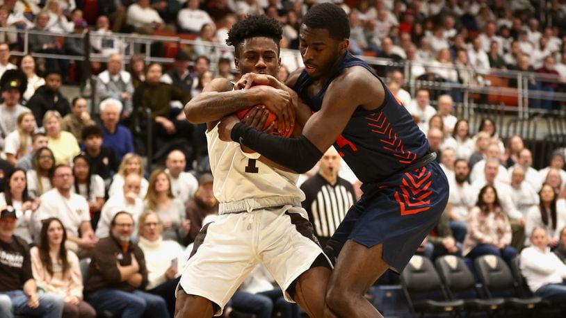 Dayton's Kobe Elvis and St. Bonaventure's Kyrell Luc compete for a ball on Saturday, Feb. 4, 2023, at the Reilly Center in St. Bonaventure, N.Y. David Jablonski/Staff