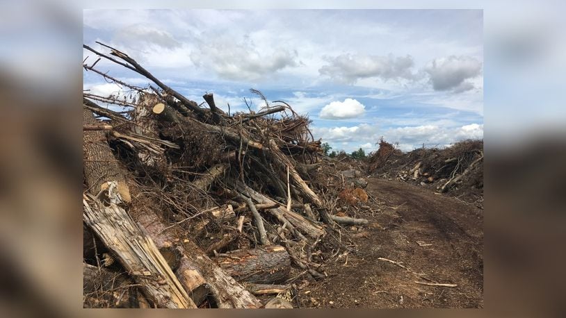 The mountain of debris collected at the Greene County Environmental Services property in Xenia is estimated at 80,000 cubic yards, which compares to a stack of 800 semi-tractortrailers. RICHARD WILSON/STAFF