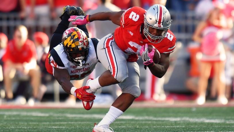 COLUMBUS, OH - OCTOBER 7: Antoine Brooks #25 of the Maryland Terrapins hangs on to make the tackle on J.K. Dobbins #2 of the Ohio State Buckeyes in the second quarter after a run at Ohio Stadium on October 7, 2017 in Columbus, Ohio. (Photo by Jamie Sabau/Getty Images)