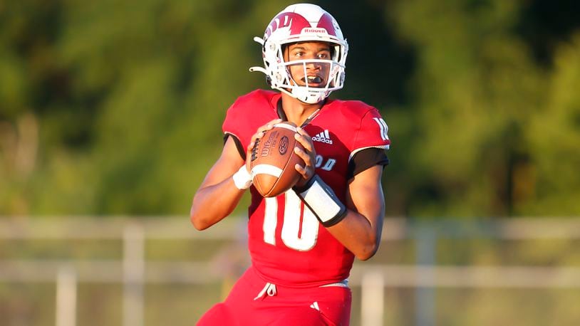 Trotwood-Madison High School quarterback Timothy Carpenter drops back to pass during their game against Alter on Thursday night in Trotwood. The Rams trailed by 10 points in the fourth quarter, but rallied to win 26-24. CONTRIBUTED PHOTO BY MICHAEL COOPER