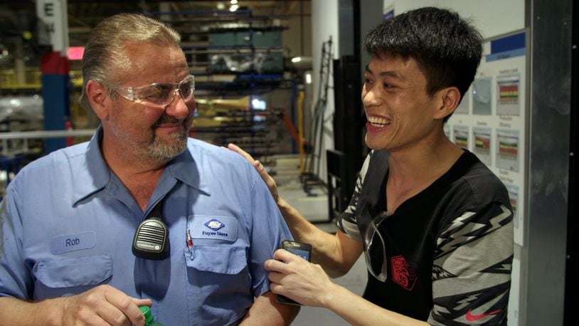 Rob Haerr and Wong He working together at the Fuyao Glass America plant in Moraine, in a photo from the film "American Factory." CONTRIBUTED