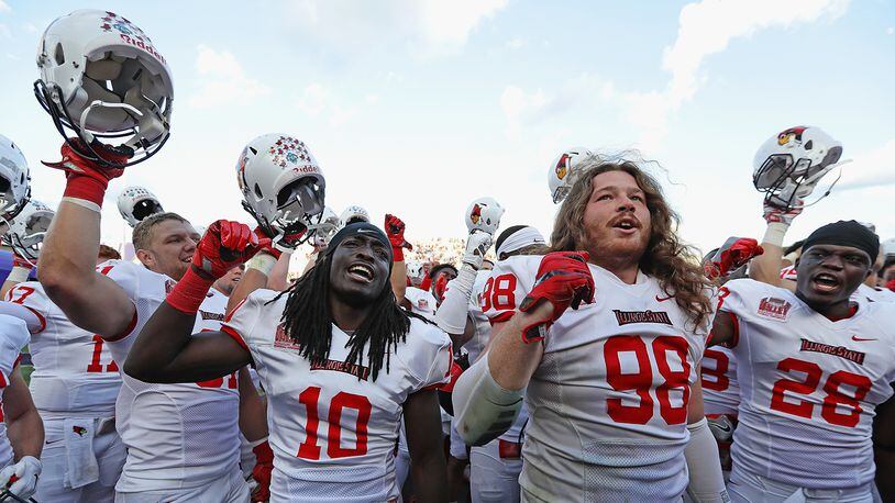 EVANSTON, IL - SEPTEMBER 10: (L-R) Bryce Holm #31, Davontae Harris #10 and Dalton Keene #98 and Kyle Williams #28 of the Illinois State Redbirds celebrate after a win against the Northwestern Wildcats at Ryan Field on September 10, 2016 in Evanston, Illinois. Illiinois State defeated Northwestern 9-7. (Photo by Jonathan Daniel/Getty Images)