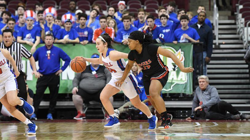 Carroll’s Allie Stefanek (left) tries to drive past Diamond Ezell of Toledo Rogers player during Saturday’s Division II championship game at the Schottenstein Center in Columbus. Nick Falzerano/CONTRIBUTED