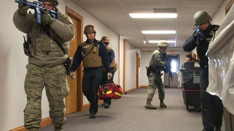 Wright-Patterson Air Force Base defenders and emergency response personnel enter a base facility during a previous active-shooter exercise. Active-shooter response will be the focus of a base-wide exercise Feb. 26. (U.S. Air Force photo/Wesley Farnsworth)