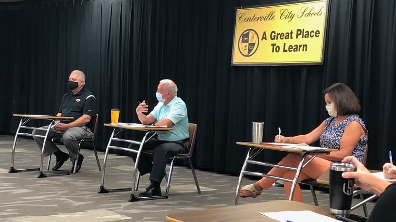From left, Centerville school board President John Doll, Superintendent Tom Henderson and school board member Allison Durnbaugh discuss COVID protocols at a public meeting. JEREMY P. KELLEY / STAFF