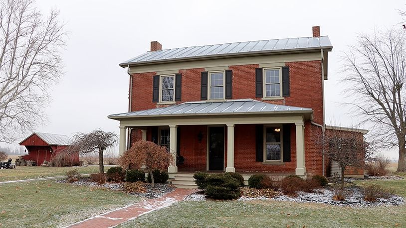 The brick farmhouse is one of five buildings on the 11-acre property. The 3-bedroom home has 3,120 sq. ft. of living space with a sun room and update kitchen and baths. CONTRIBUTED PHOTO BY KATHY TYLER