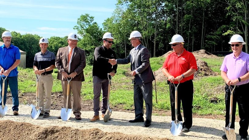 Greene County Sanitary Engineering Director Jason Tincu (center left) shakes hands with County Commissioner Tom Koogler as the county breaks ground on a water treatment plant upgrade that will add 3 million gallons to its capacity. LONDON BISHOP/STAFF