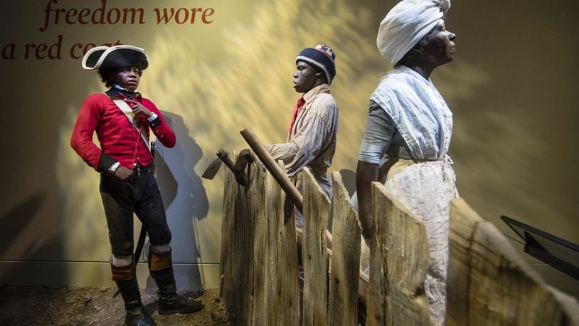 This Thursday, April 13, 2017 photo depicts a fourteen-year-old London Pleasants, left, who left slavery by joining a Loyalist regiment encouraging other slaves to flee to the British Army in search freedom, at the Museum of the American Revolution in Philadelphia. (AP Photo/Matt Rourke)