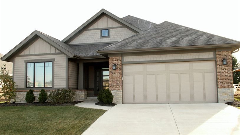The split floor plan ranch has a full basement with finished areas that include a recreation room with wet bar area, a full bathroom and a possible fourth bedroom. The main level has an open-concept social area with a dual-sided gas fireplace as the centerpiece. CONTRIBUTED PHOTOS BY KATHY TYLER