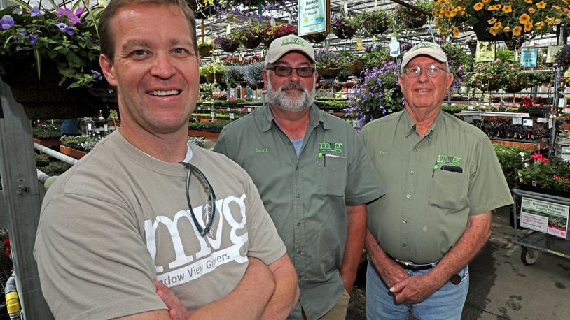 Jeff Pack, the new owner of Meadow View Growers, left, wants people to know that Scott, center, and Earl are still going to be around and working at the garden center. Bill Lackey/Staff