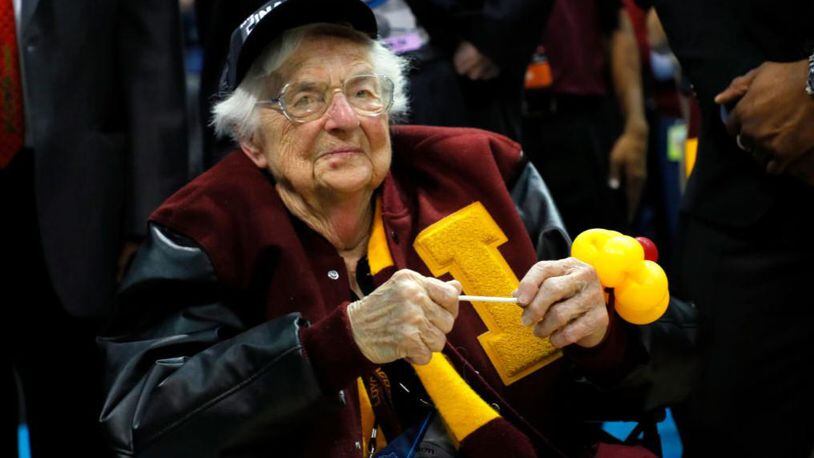 Sister Jean Dolores Schmidt celebrates with the Loyola Ramblers after the team defeated the Kansas State on Saturday in Atlanta.