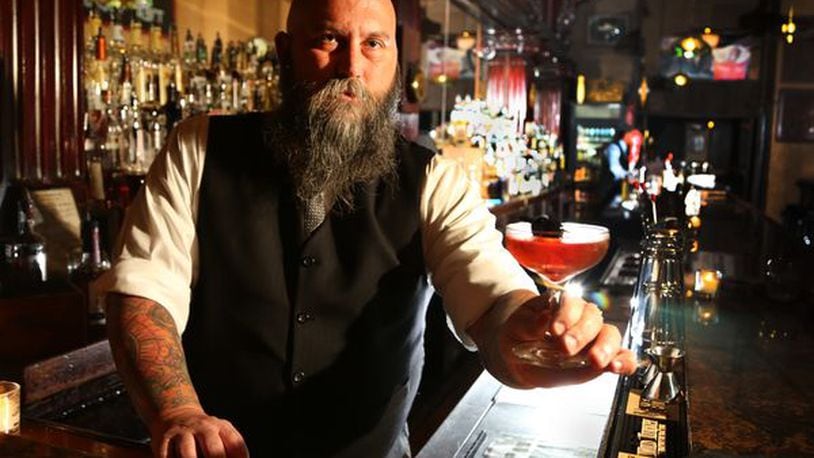 Century Bar co-owner Joseph Head shows off the bar’s cocktail called “Remember the Maine,” made with Rye Whiskey, Cherry Liqueur, Bitters, Bulliet Rye and Sweet Vermouth. Staff file photo JIM WITMER/STAFF
