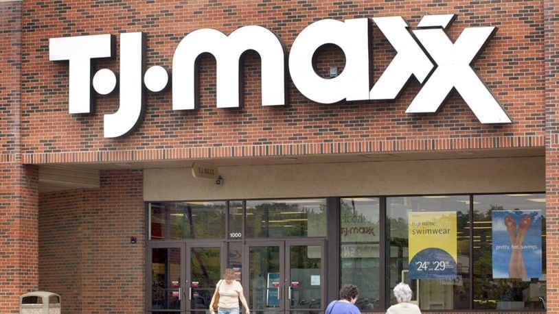 Shoppers are seen walking in front of a T.J. Maxx store. (Photo by Tim Boyle/Getty Images)