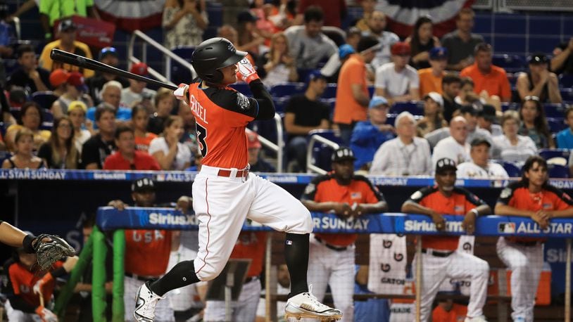 Nick Senzel of the Reds and the U.S. Team hits an RBI double in the first inning against the World Team during Monday's SiriusXM All-Star Futures Game at Marlins Park.