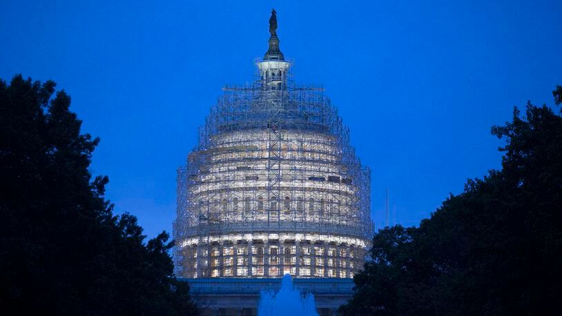 Scaffolding surrounds the U.S. Capitol Building while it undergoes repairs in Washington, D.C., U.S., on Wednesday, Nov. 5, 2014. Republicans roared back in the midterm elections on Tuesday, capturing control of the Senate from Democrats, winning crucial governor races and solidifying their majority in the U.S. House. Photographer: Andrew Harrer/Bloomberg via Getty Images