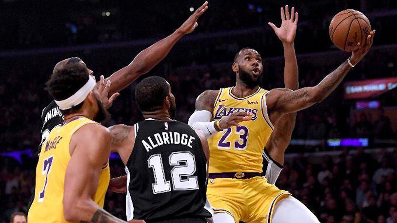 LeBron James of the Los Angeles Lakers attempts a layup past LaMarcus Aldridge of the San Antonio Spurs during the first half at Staples Center on Oct. 22, 2018, in Los Angeles.