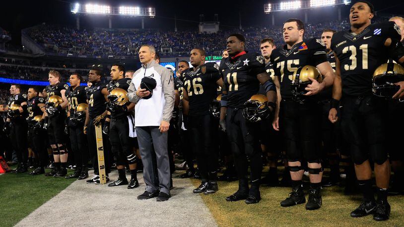 Head coach Jeff Monken of the Army Black Knights stands with his players and sings the teams fight song following their 17-10 loss to the Navy Midshipmen at M&T Bank Stadium on December 13, 2014 in Baltimore, Maryland. (Photo by Rob Carr/Getty Images)
